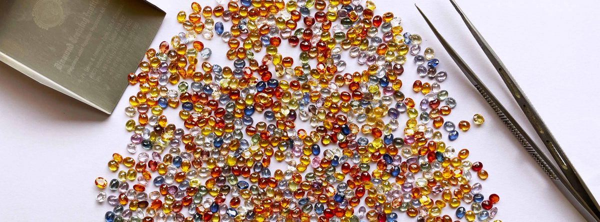 Assorted colorful faceted gemstones at Mittal gems.